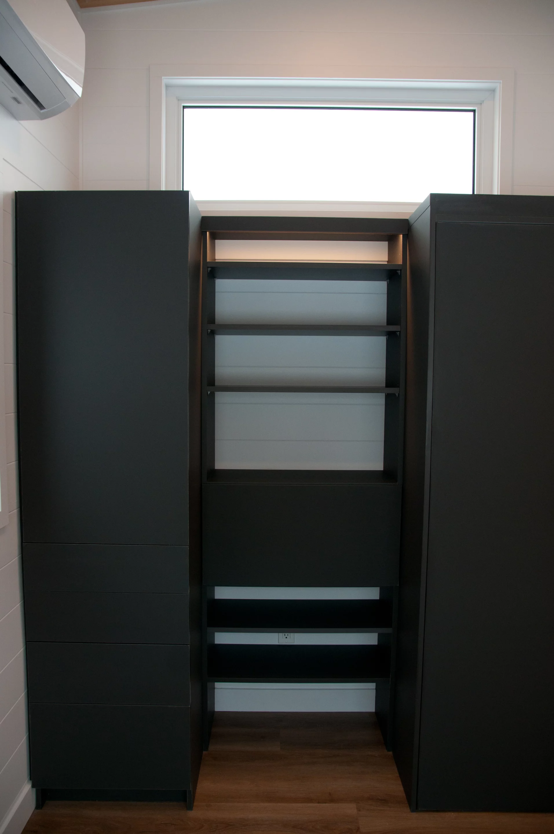 The Noyer XL's master bedroom has lots of headroom to stand upright (which is still relatively rare in tiny houses). It also includes some storage units, and a small drop-down desk area