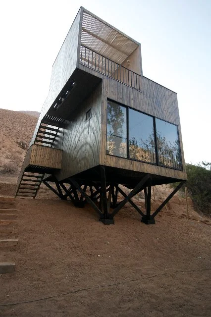 Each cabin is slightly raised above the ground and features a graded interior design