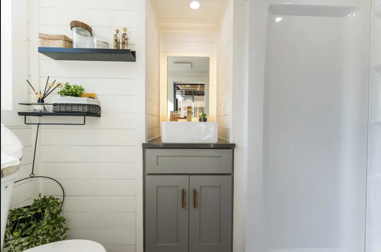 The Vista's bathroom includes a vanity sink, shower, and flushing toilet