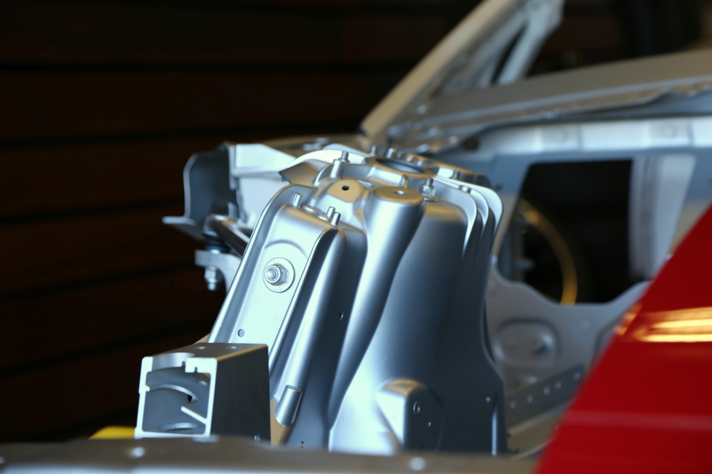 A detailed view of the F-type's suspension tower as shown in this cutaway model at Laguna Seca (Photo: Angus MacKenzie/Gizmag.com)