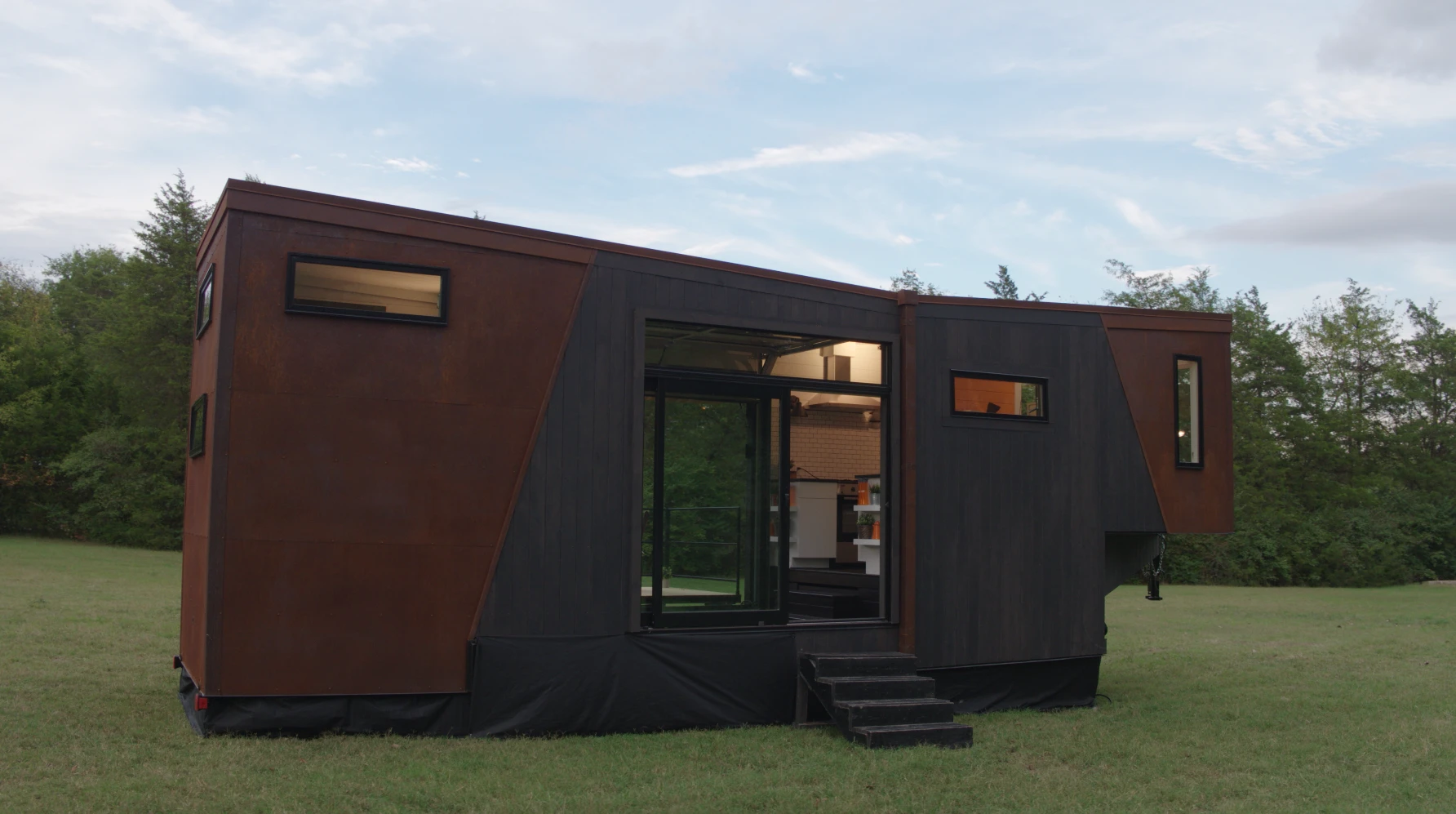 The Home That Runs on Dunkin' is reached by a small staircase and entered by glass sliding doors