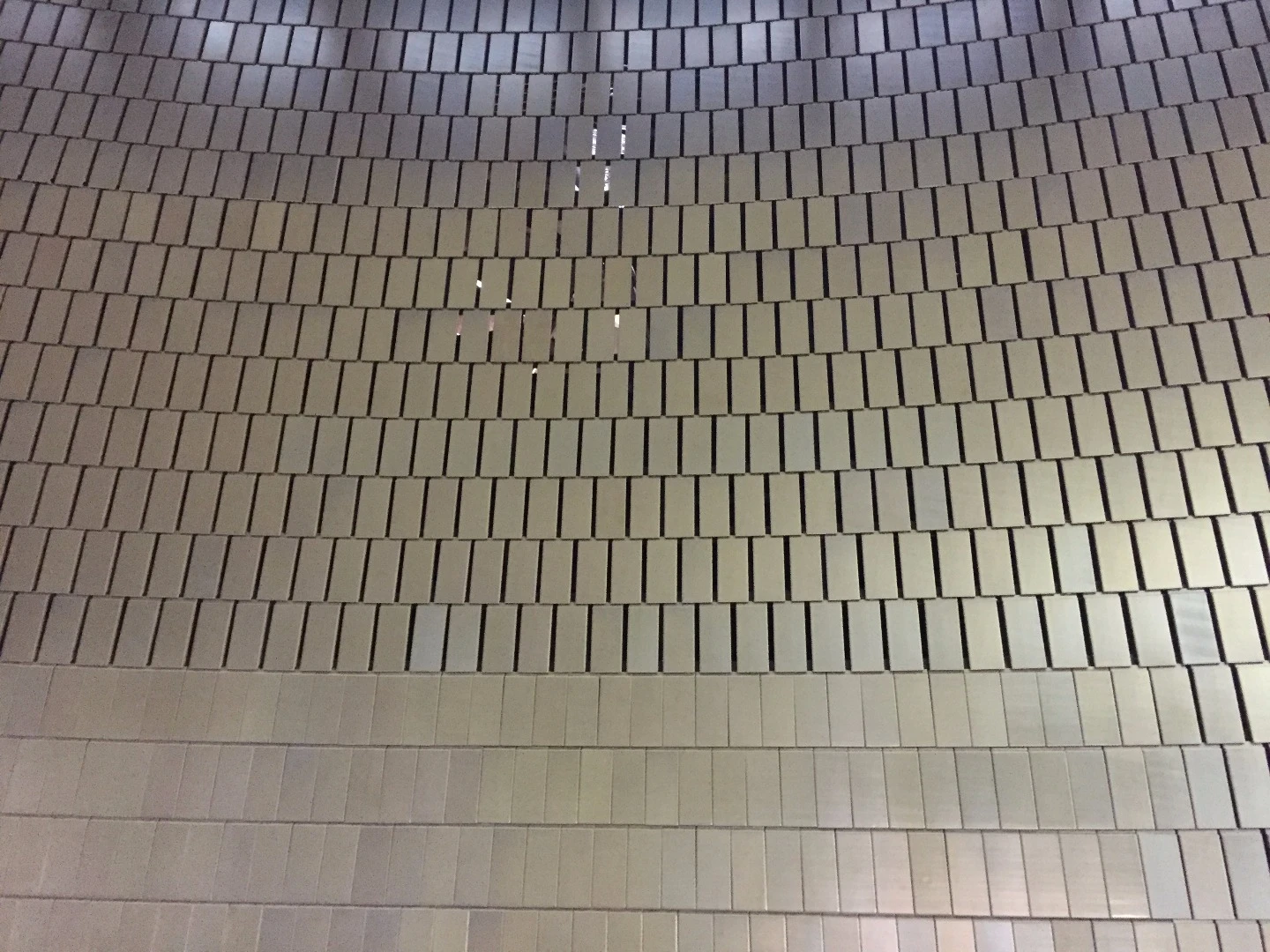 "Our goal was to attenuate sound by half if possible at ALL frequencies from the lobby to the top gallery. In order to achieve this we needed to have a low frequency slot absorbing system, (similar to a Helmholtz resonator)"