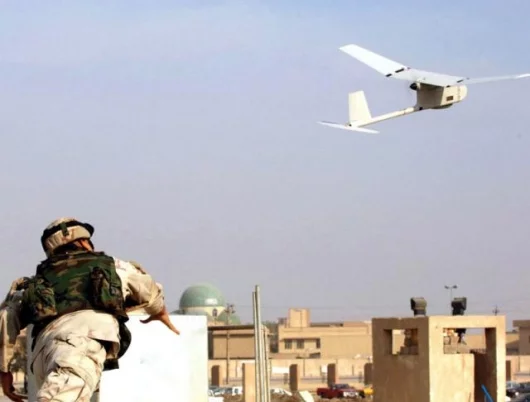 Sgt. Juan Rivera, from 1st Battalion, 9th Field Artillery Regiment, 3rd Infantry Division, launches the RAVEN unmanned aerial vehicle into the skies over downtown Baghdad, to take surveillance photos during December, 2005