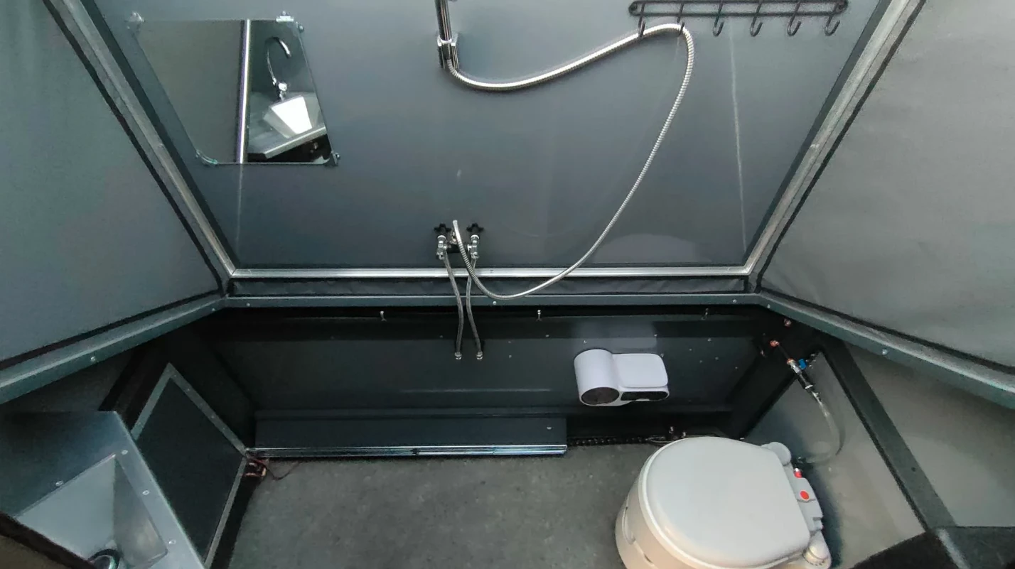 The front of the interior is dedicated to the wet bath, which can be left open at the top for scenic showering or fully enclosed for more privacy