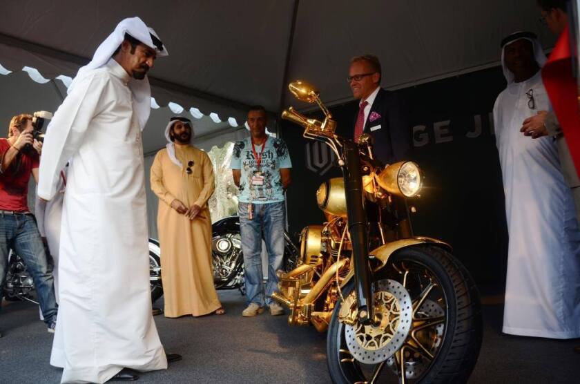 Lauge Jensen set an unofficial world record for the sale of a new motorcycle earlier this year (2014) when it sold a one–off motorcycled dubbed "Goldfinger" motorcycle for a reported US$850,000. This image from the 2013 Gulf Bike Week in Dubai shows former Rally driver and FIM heavyweight His Excellency Mohammed Ben Sulayem looking over Goldfinger at Gulf Bike Week in October, 2013.