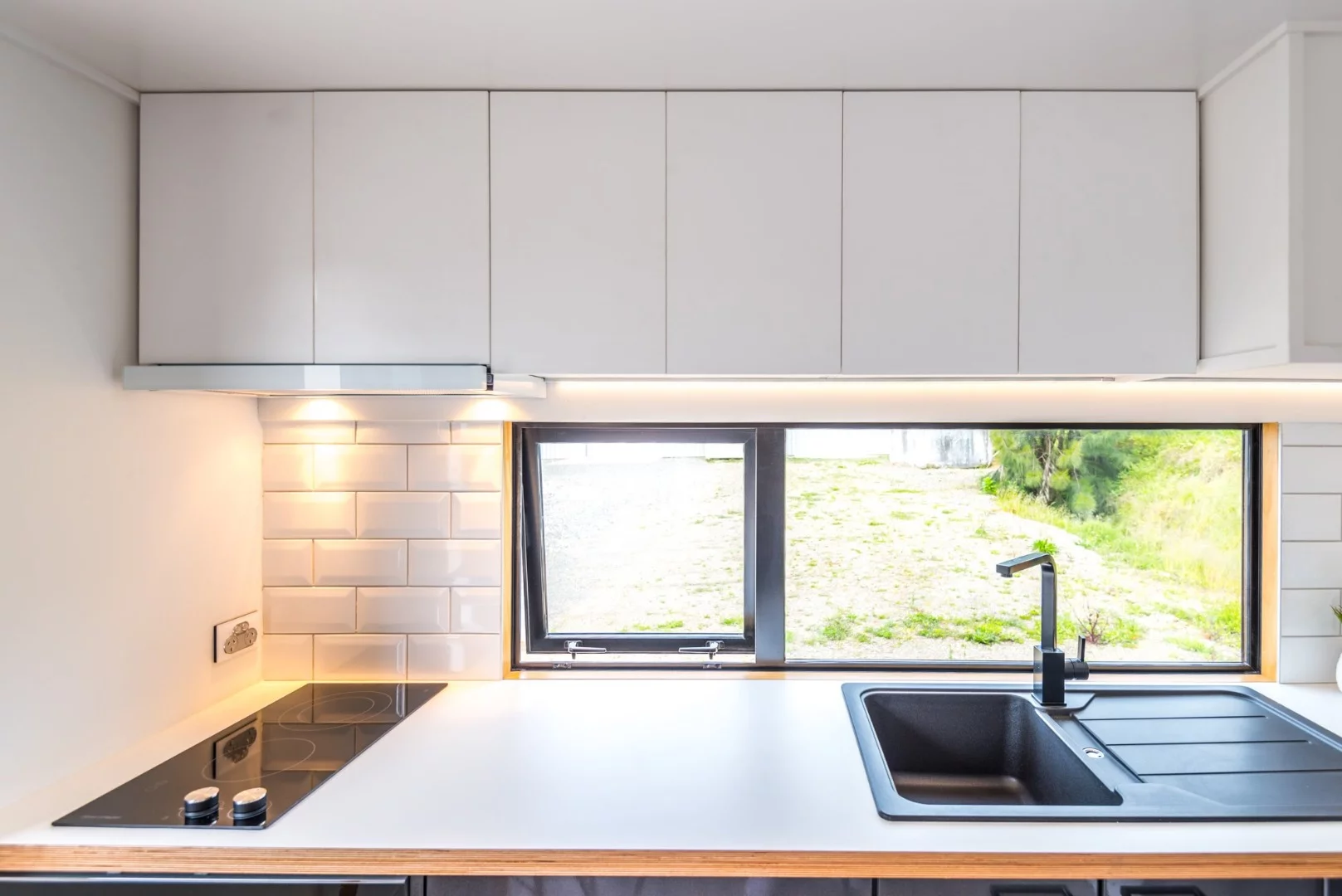 Overhead cupboards are featured in the kitchen for ample storage