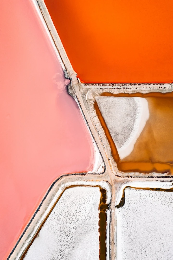 The Salt Series: Chronicling the harvesting of sea salt using artificially created ponds. The color of the water indicates the salinity of the ponds with micro-organisms changing their hues as the salinity of the pond increases