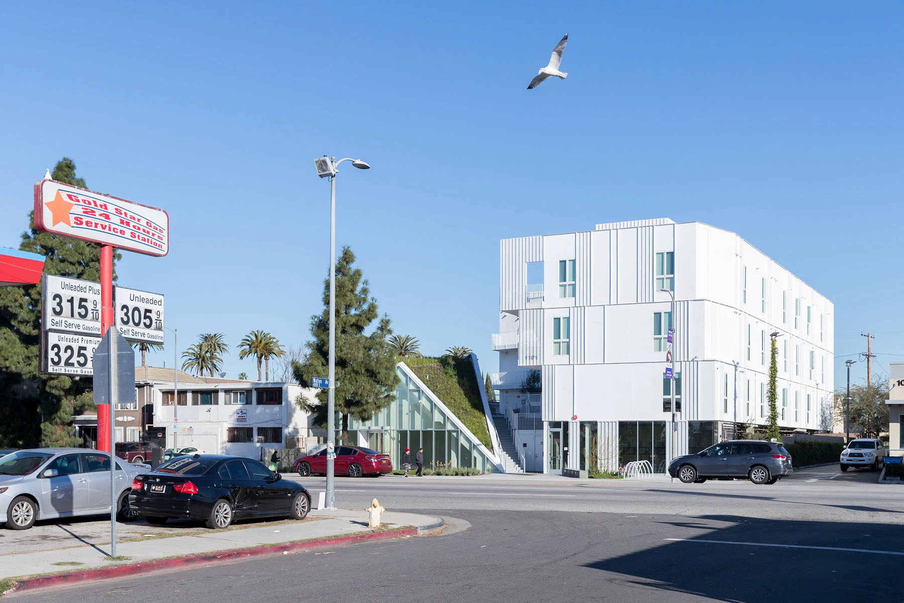 MLK1101 Supportive Housing consists of a large L-shaped four-story building and a second smaller green-roofed building that contains a community room