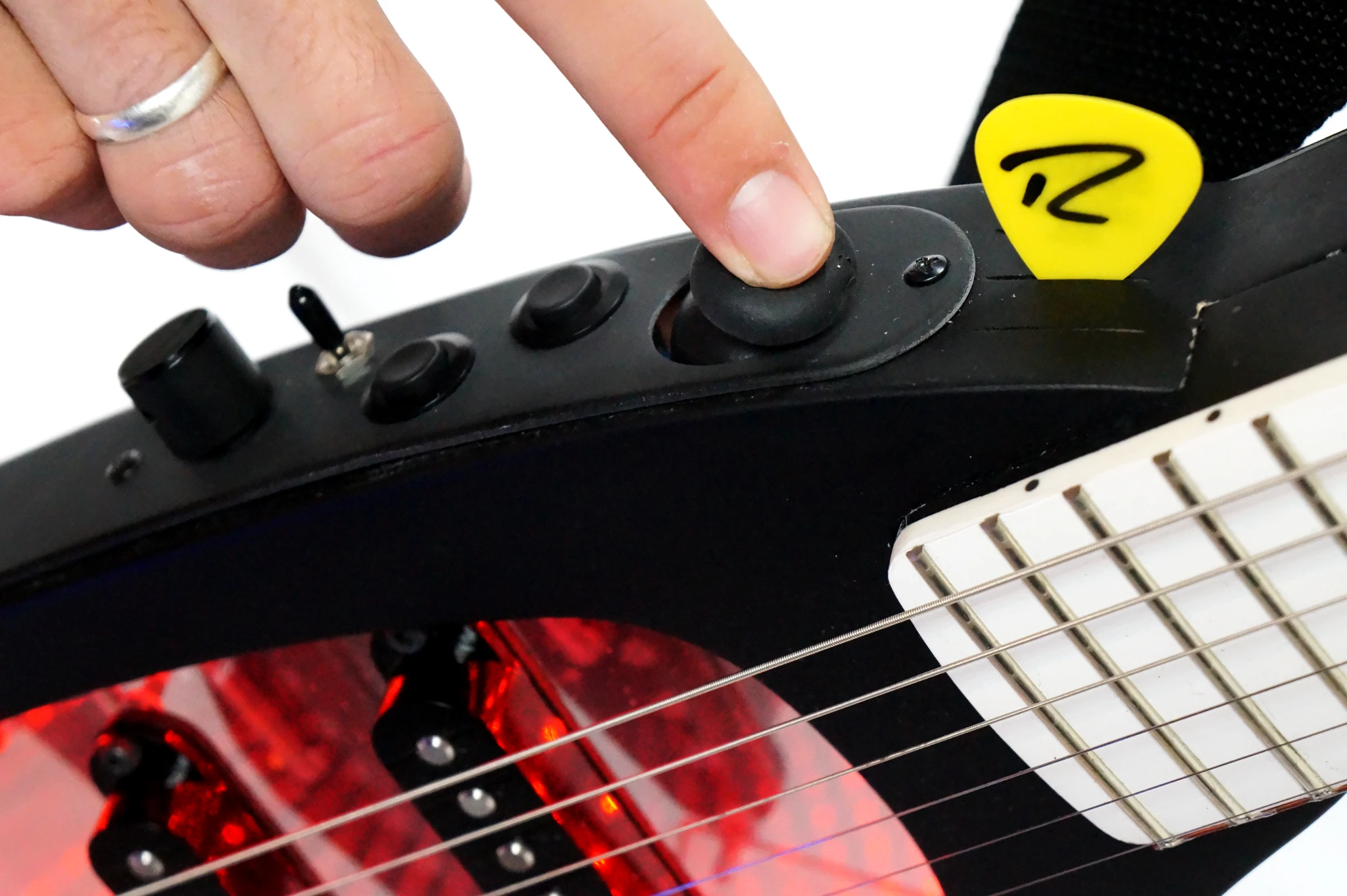 Controls are placed on top of the matte black laminate wood body, with space to store three picks while tapping two-handed on the neck