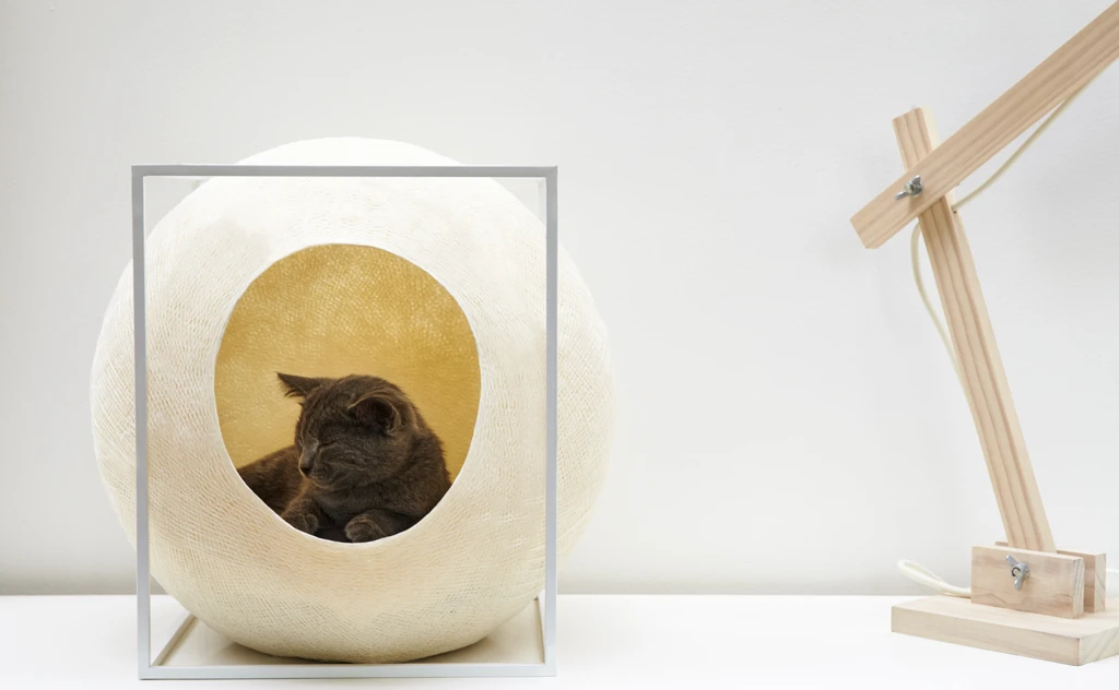 The Cube consists of a soft cotton cocoon within a metal frame