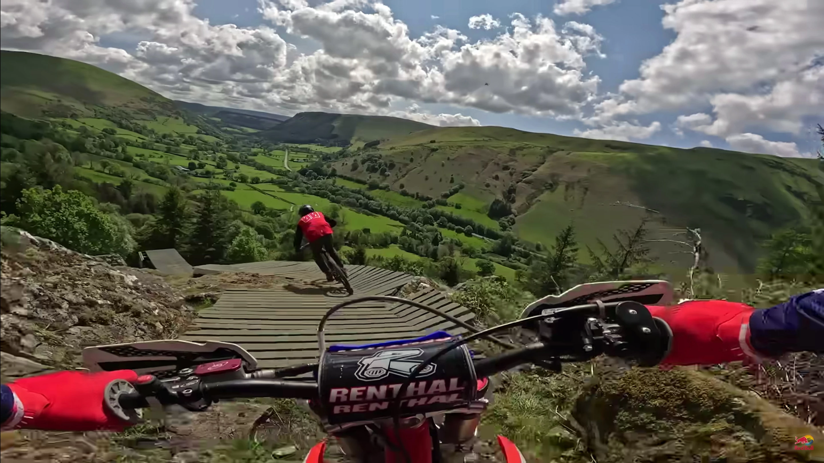 Johnny Walker rides behind the Red Bull VJ about to huck the road gap in which is probably the very first time pedal and motor have ever ridden together on Hardline
