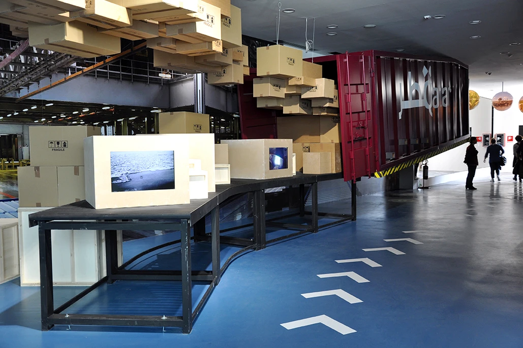 Digital displays made of cardboard cargo boxes in the Qatar Pavilion