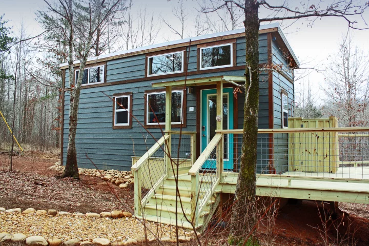 The Lykke has been installed in a forest and has a wraparound deck to increase living space