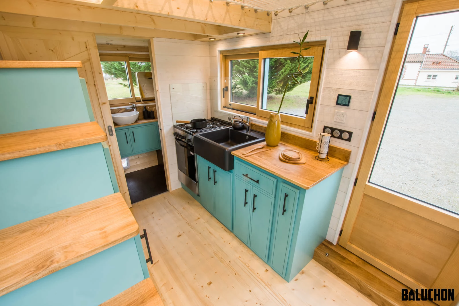 The Tiny house Kalzennig's kitchen includes a fridge/freezer and a