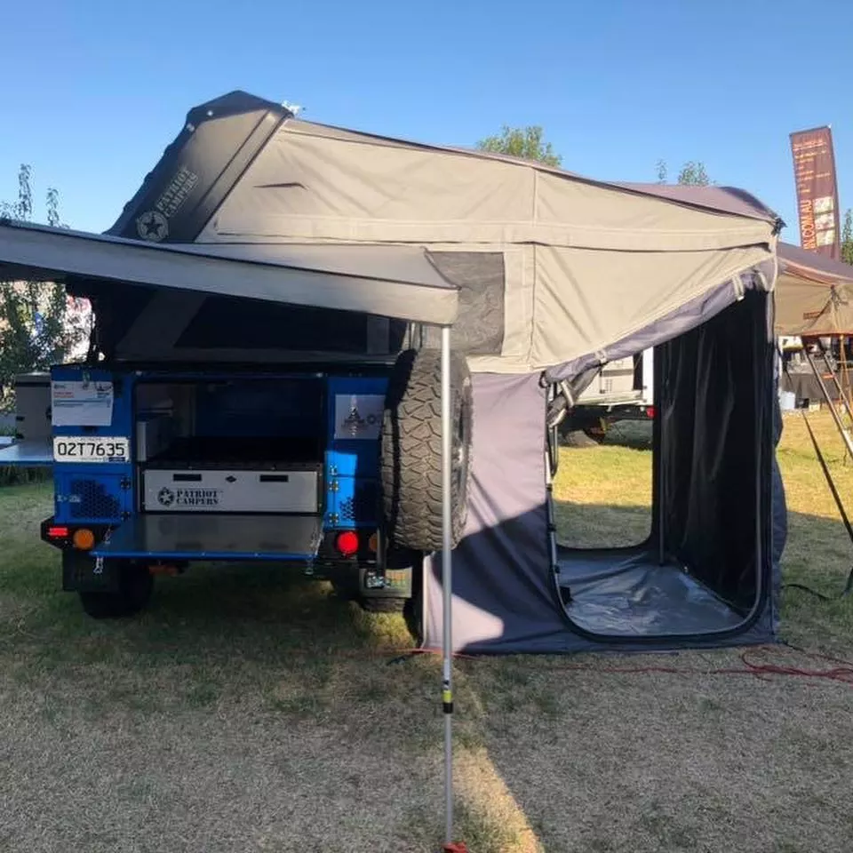 The changing room secures to the tent awning, offering added shelter space for changing clothes