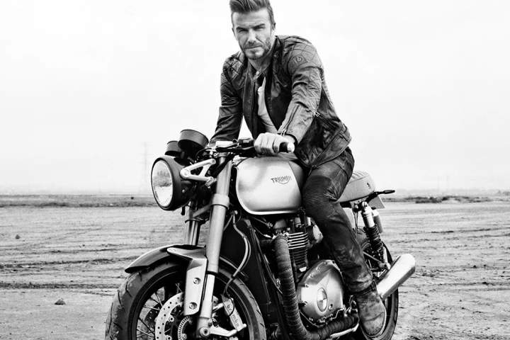David Beckham as the star of the "Outlaws" film aboard a new cafe racer Bonnie gives us a clear indication of what Triumph is about to unveil – notice the radiator that is cleverly hidden between the frame downtubes