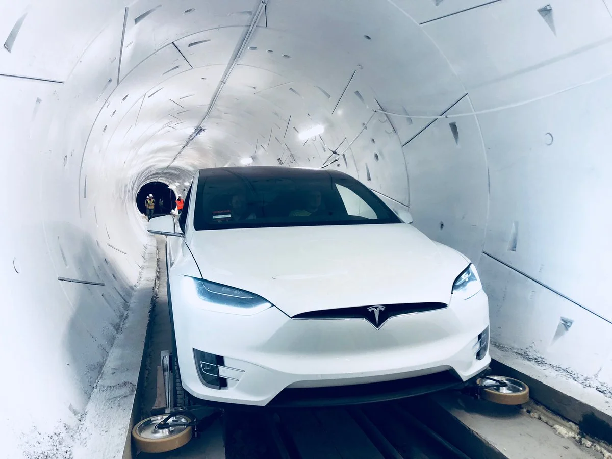 A Tesla inside The Boring Company's first tunnel, fitted with retractable wheel gear