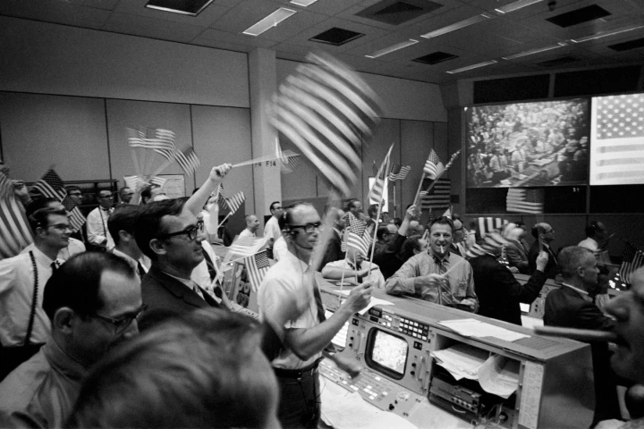 Flight controllers seen celebrating the Apollo 11 mission on Jul 24, 1969