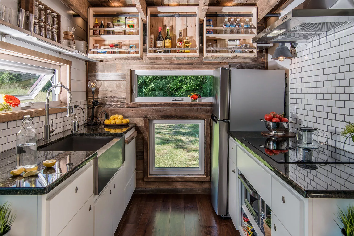 One kitchen wall and the ceiling are clad in reclaimed barn wood