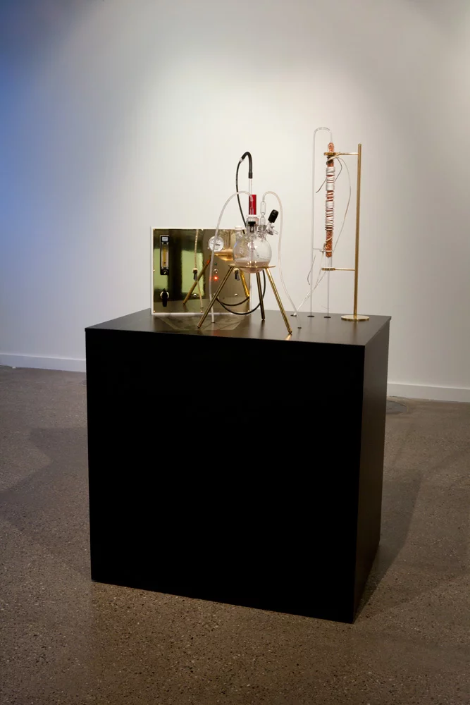 The Great Work of the Metal Lover is a portable laboratory featuring a highly specialized metallotolerant extremophilic bacterium called Cupriavidus metallidurans that's forced to metabolize huge amounts of gold chloride to form flecks of usable 24K gold (Photo: Adam Brown)