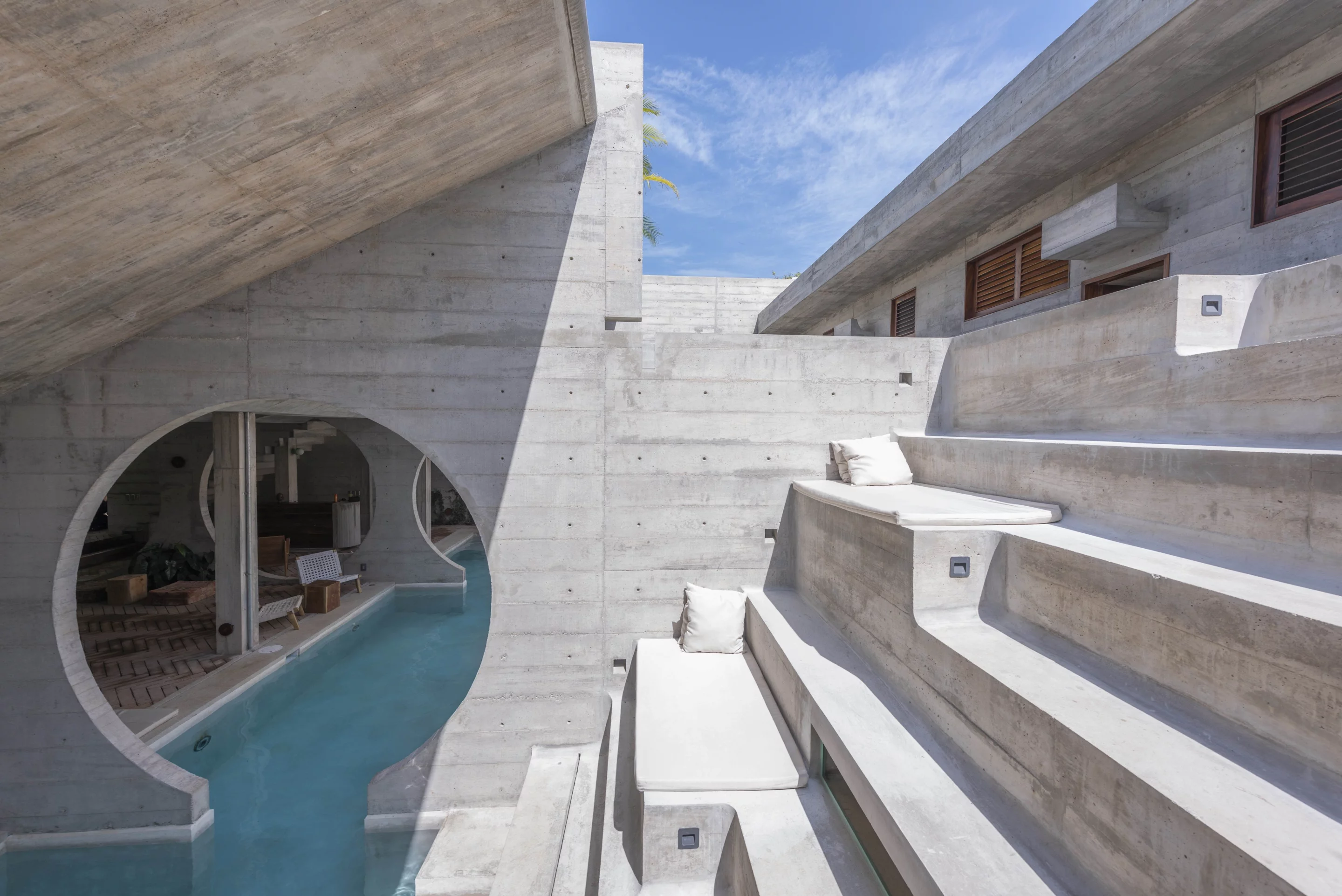 Guests can relax in the sunshine, while also enjoying privacy provided by the separating concrete volumes