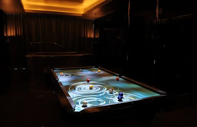 The CueLight Interactive Pool Table System projects an animated display on pool tables, that follows the balls as they move