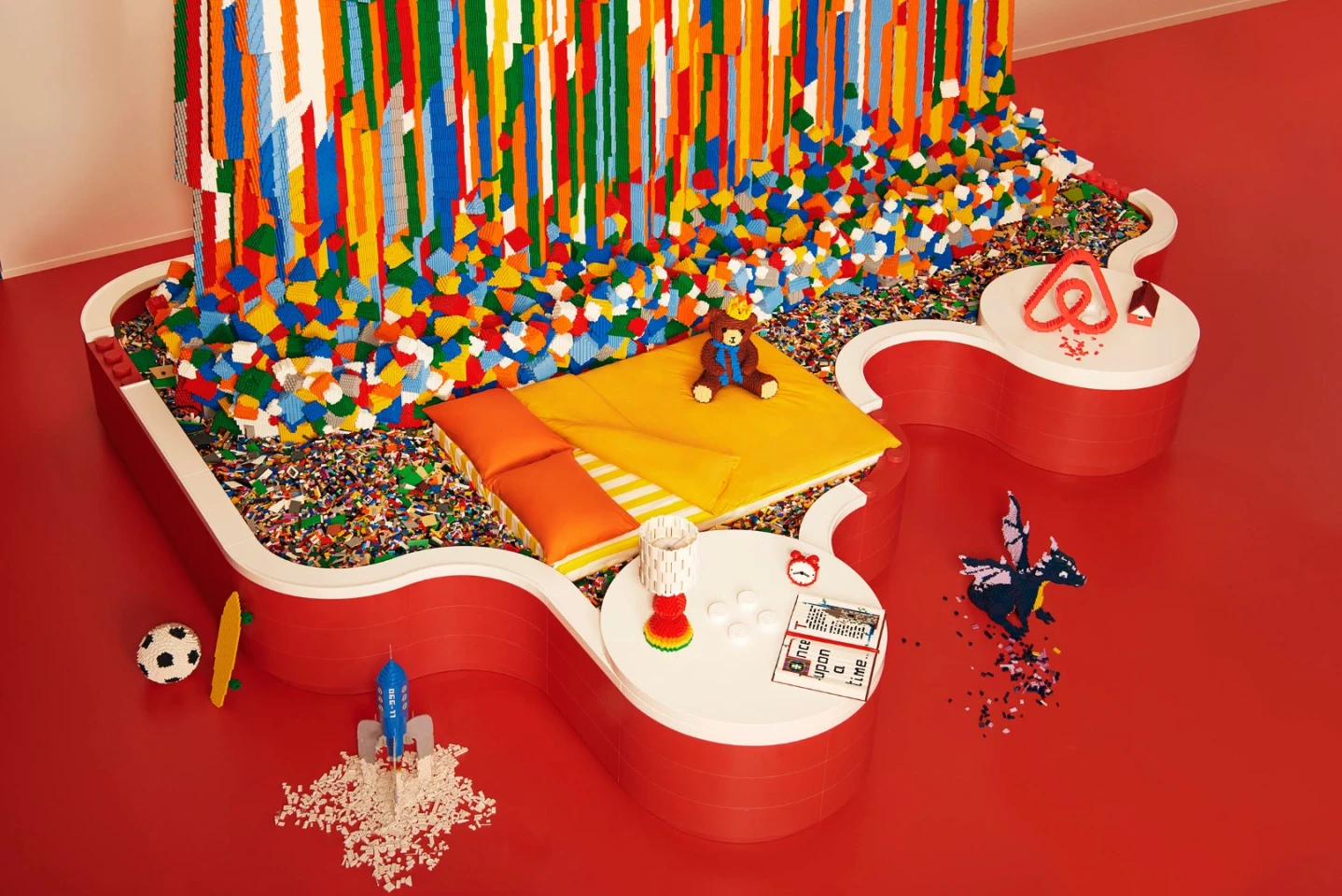 The winner gets to sleep on a bed floating in a pool of Lego