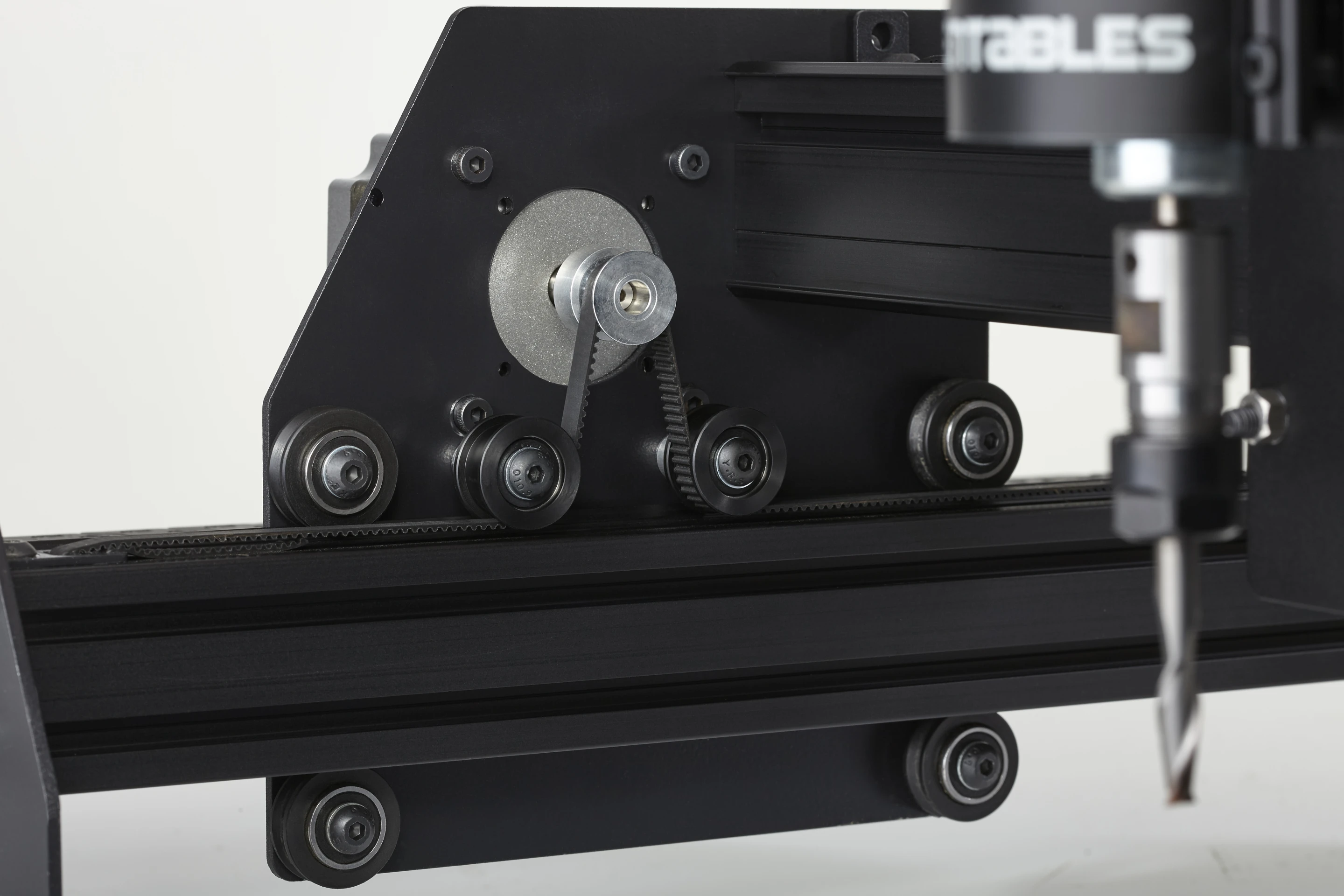 The drive belt routing of the X-Carve and on the right, the cutter motor and cutting bit