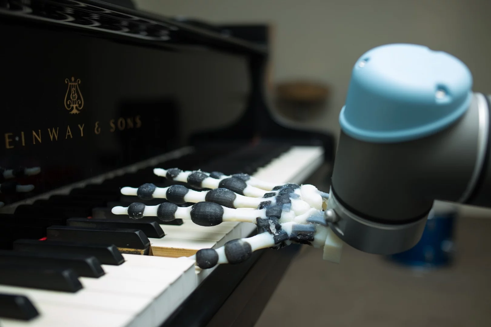 The robot hand can play simple musical phrases by rocking and rolling the wrist