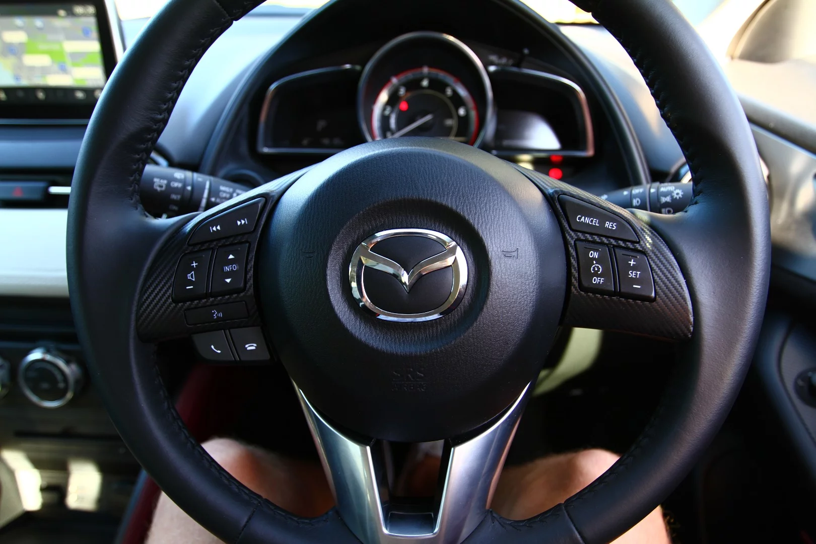 The steering wheel is covered in buttons, but it's easy to use on to go