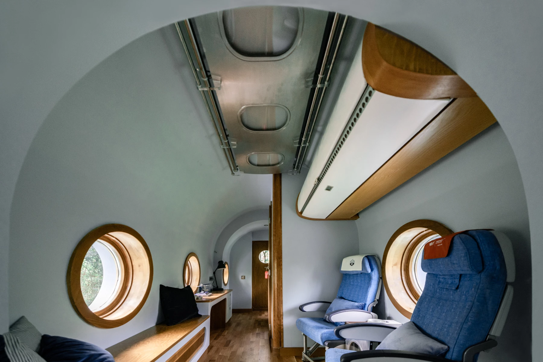 The Jet House contains authentic airplane seats and an overhead locker storage space