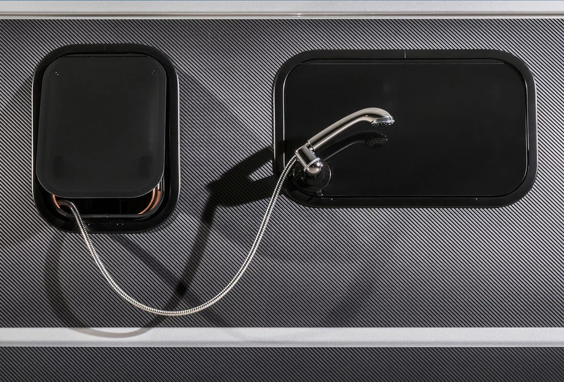 The bathroom shower pulls out the window to create an outdoor shower/sprayer