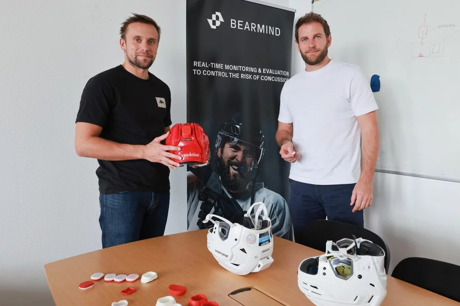 Tom Bertrand (left) and Mathieu Falbriard, with one of their Bearmind helmets