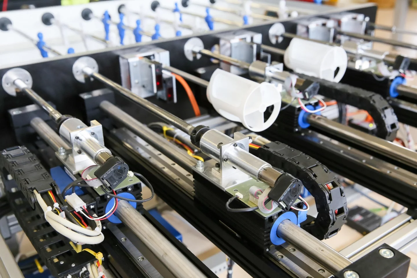 Linear motors bring the robot team's players into striking position, then another motor rotates the player to shoot