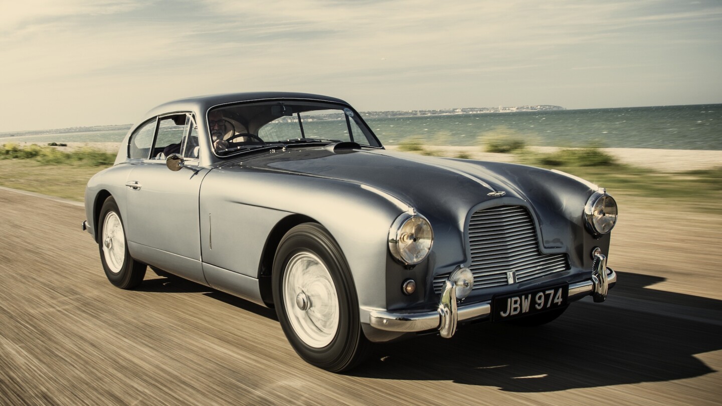 This is the 1954 Aston Martin Vantage DB 2/4 Mk I which inspired Ian Fleming to envisage the Aston Martin DB Mk III which James Bond drove in the novel Goldfinger, and subsequently became the DB5 in the movies Goldfinger and Thunderball.