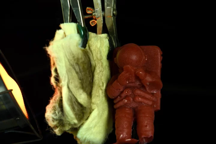 A gelatin astronaut stays unmelted when exposed to a flame, protected by the new nanofiber material