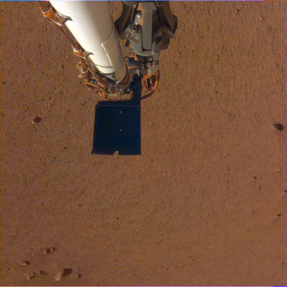 InSIght's robotic arm over Martian soil