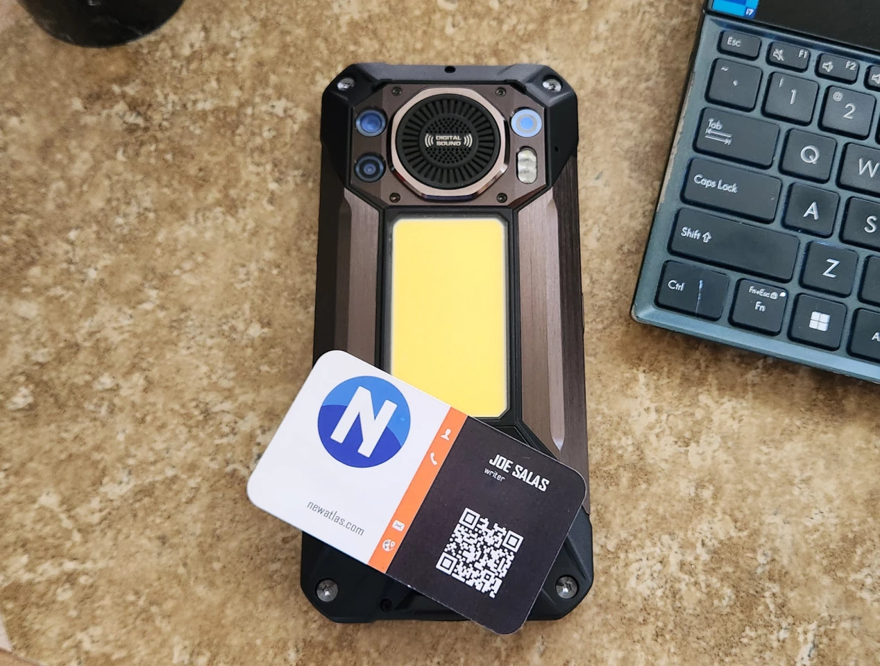 Here's the mighty phone with a standard-size business card for reference