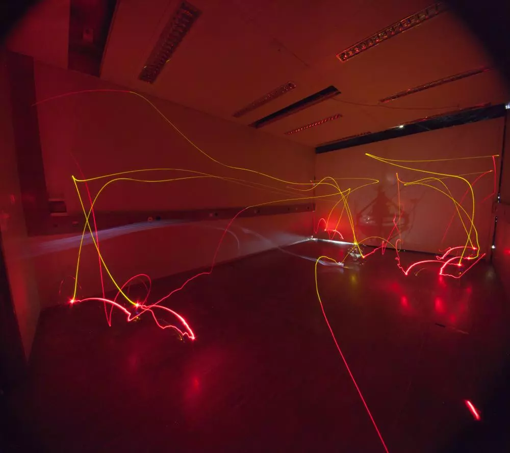 A time-lapse exposure of an AirBurr flight in a pitch-black room – the yellow lines indicate where the UAV was taking off or flying, while the red lines indicate collisions or uprighting