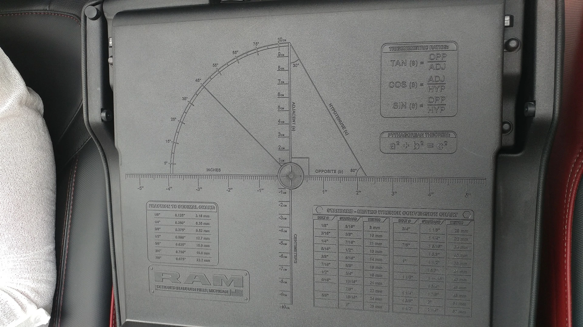 Under the center armrest storage bin is a handy chart with angles, measurements, and so forth