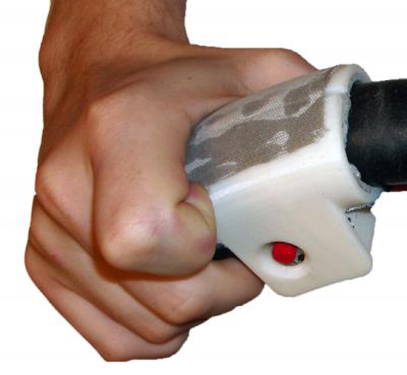Close-up of a touch-based driving navigation device attached to the steering wheel showing the red TrackPoint computer mouse taken from an old IBM ThinkPad (Image: William Provancher, University of Utah)