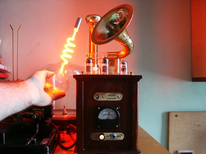 The Steampunk Plasma Speaker's resonance coil creates an electromagnetic field sufficient to light a neon bulb (Photo: Conscious Flesh)