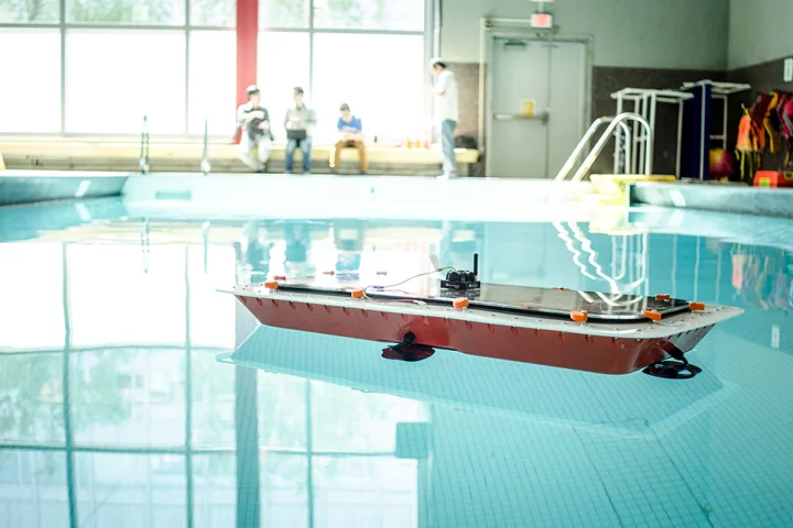 A prototype autonomous RoBoat hits the water in a swimming pool test run