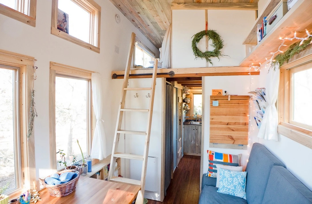 The interior floor space measures 8 x 20 ft (2.4 by 6 m) and features an elevated loft half that size