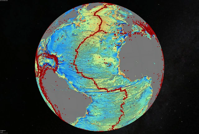 A marine gravity model of the North Atlantic with red dots showing locations of earthquakes with magnitude above 5.5 and highlighting the present-day location of the seafloor spreading ridges and transform faults (Image: David Sandwell, Scripps Institution of Oceanography, UC San Diego)