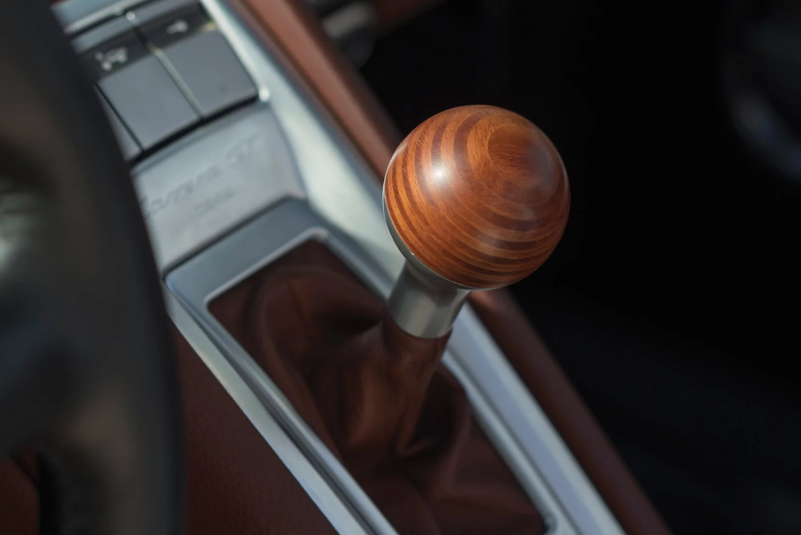 The birchwood gearknob in the Carrera GT is a throwback to the simple units in classic Porsches