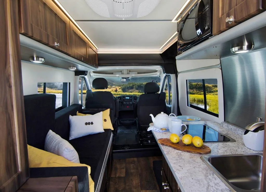 The kitchen includes a standard two-burner stove, microwave, fridge and sink