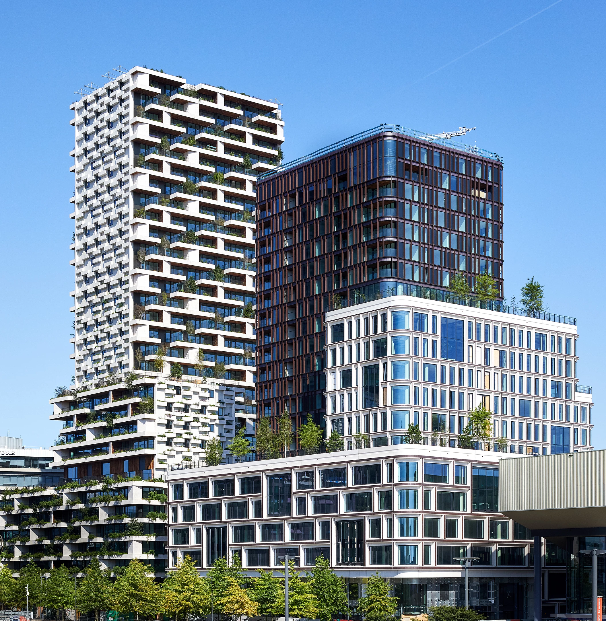 The Wonderwoods Vertical Forest is part of a larger development that includes a nearby tower that is connected by a bridge