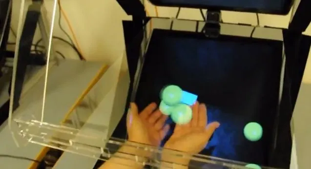 The Sensors and Devices group at Microsoft Research has developed a new system called HoloDesk that allows users to pick up, move and even shoot virtual 3D objects