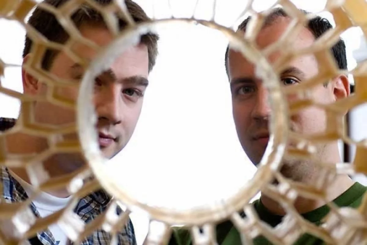 Eric Foltz (left) and Nick Newman look through the honeycomb pattern of an early prototype of a non-pneumatic tire. Foltz, Newman and Osswald (not pictured), worked with Resilient Technologies to design and develop the airless vehicle tire for military us